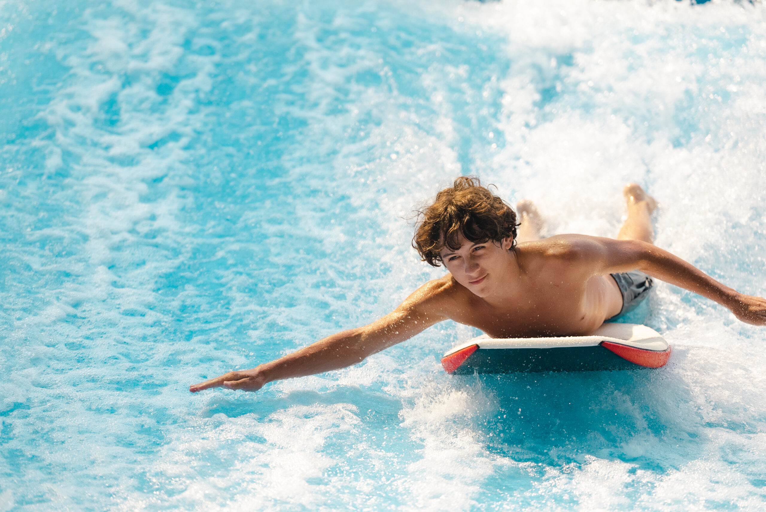 Young man with curly hair on Flowrider