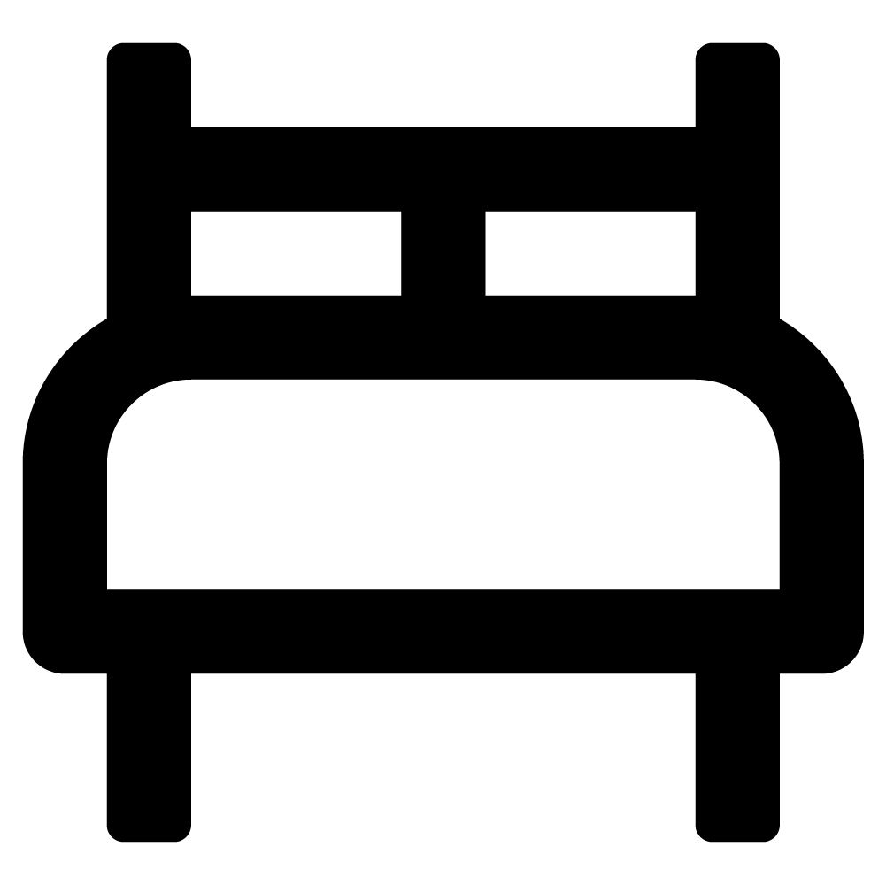 Black and white icon of a bed seen from the front, with a headboard and two pillows.