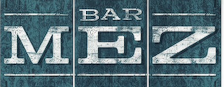 A textured blue-green sign with the words BAR MEZ in large, bold, white letters.